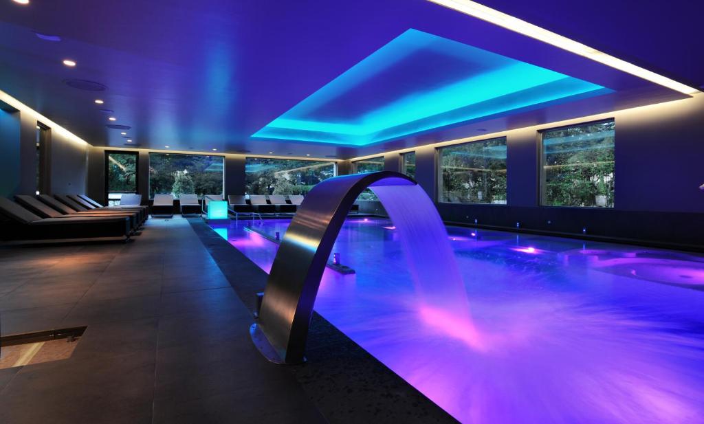 a swimming pool in a hotel with purple lighting at Hotel San Giorgio in Fiuggi
