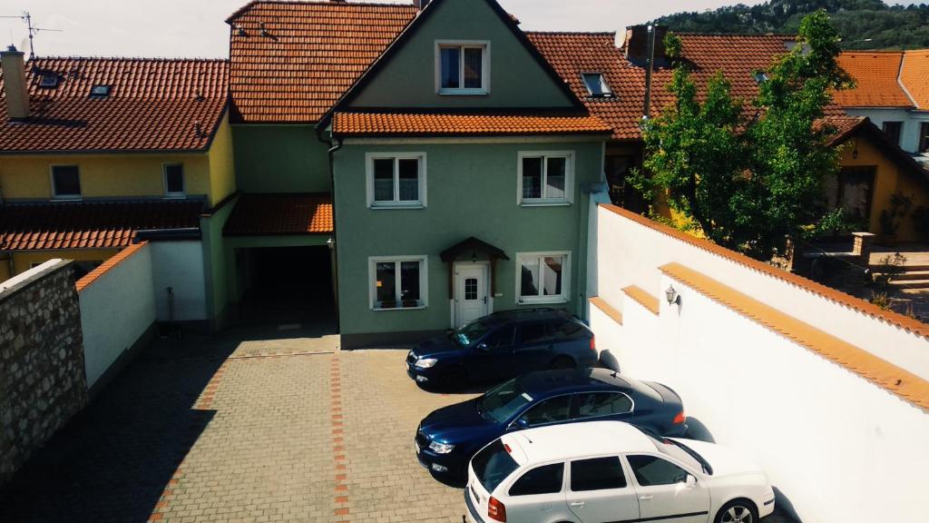 two cars parked in a parking lot in front of a house at Pod Vinicí in Mikulov