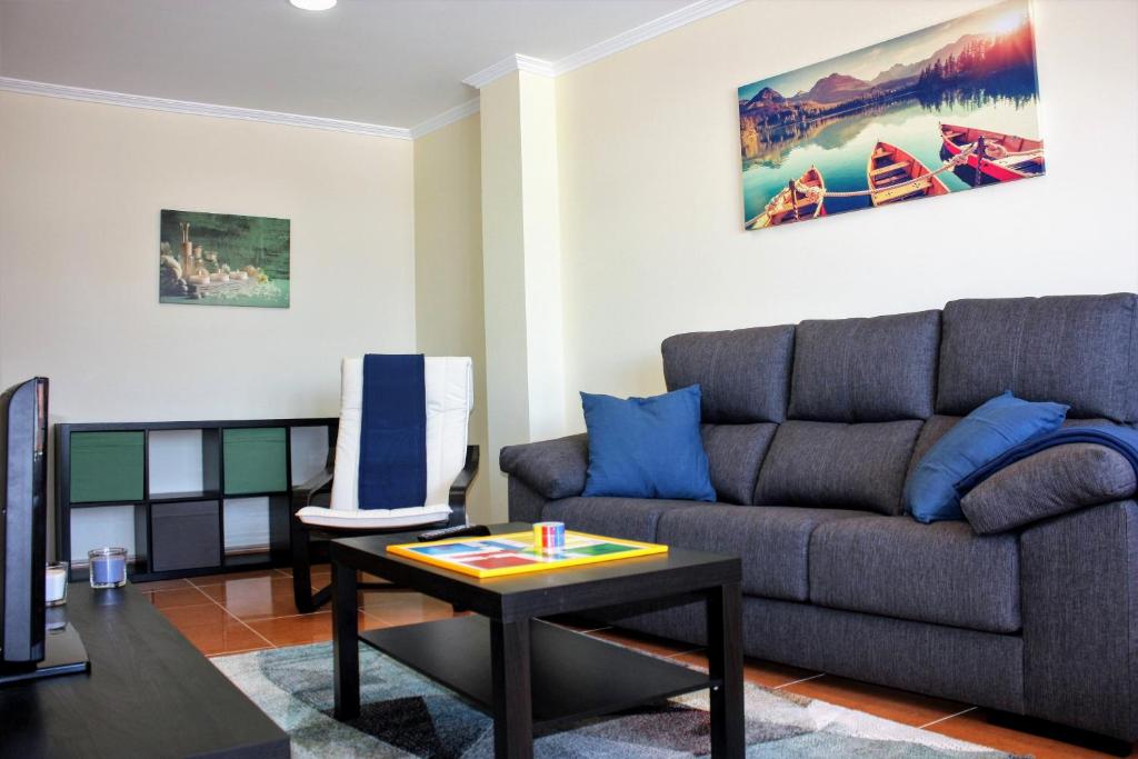 a living room with a couch and a table at Apartamento en centro de Fisterra in Fisterra