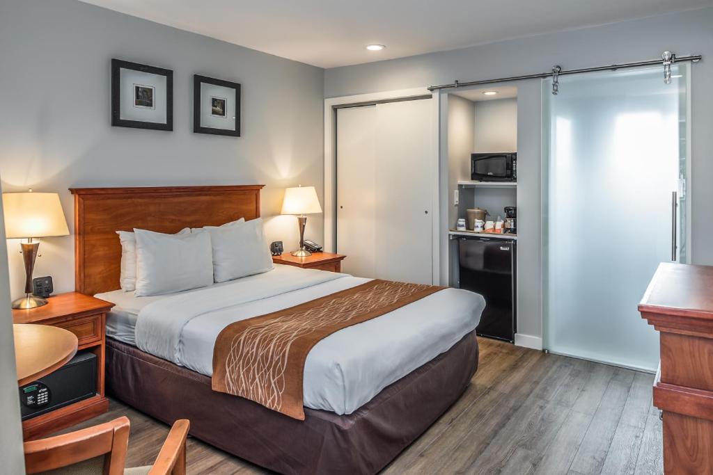 a hotel room with a bed and a kitchen at The Inn at 1252 Monterey in Monterey