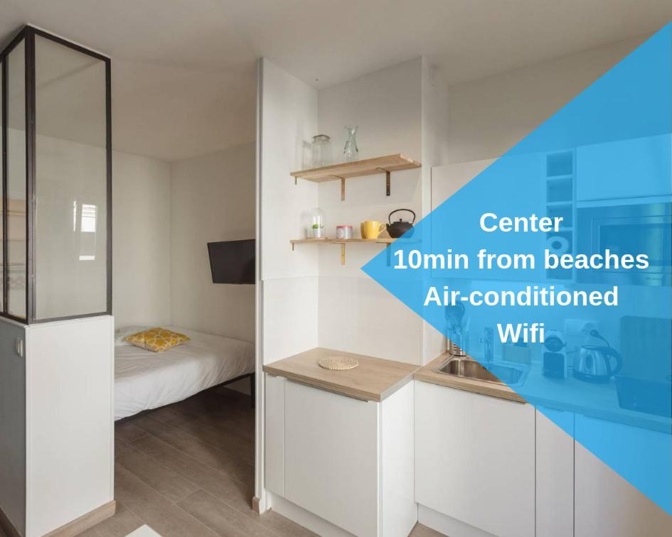 a room with a room with a bed and a refrigerator at Nicelidays - Le Berlioz - city central - 7min from beaches in Nice