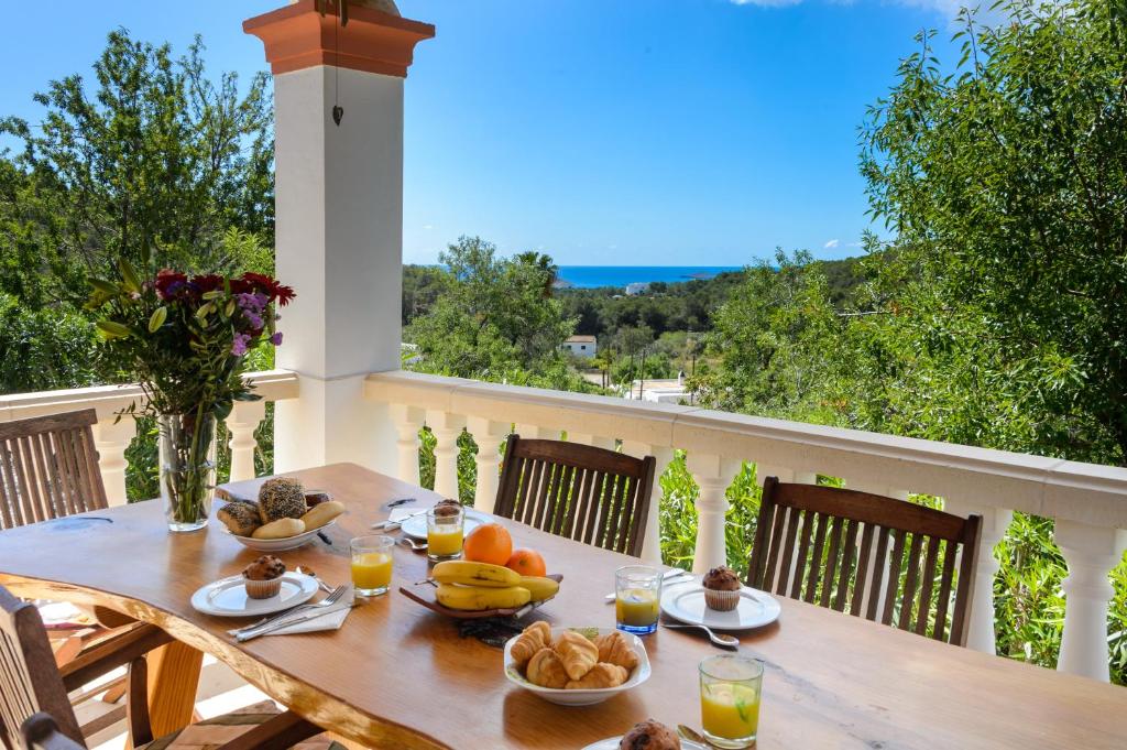 a table with food and fruit on a balcony at Villa Can Ameler in Sant Carles de Peralta