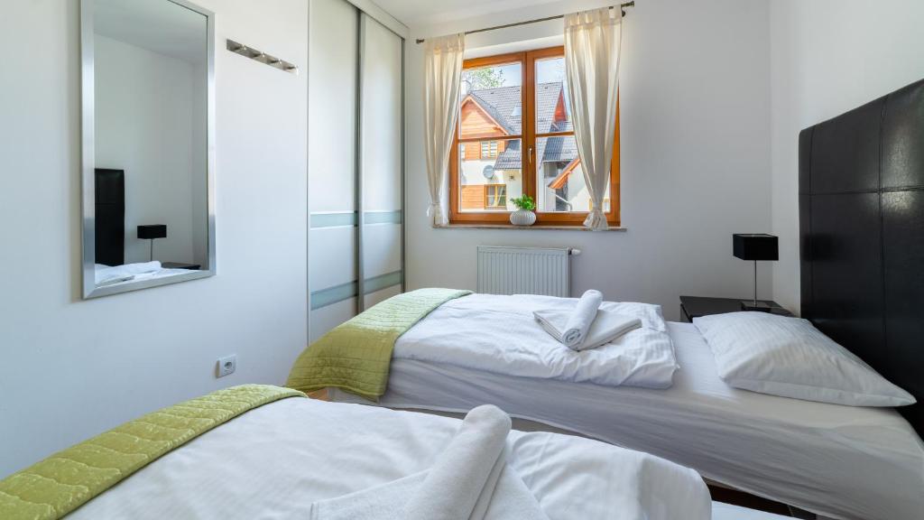 Posteľ alebo postele v izbe v ubytovaní Apartamenty Sun & Snow Karpacz Myśliwska