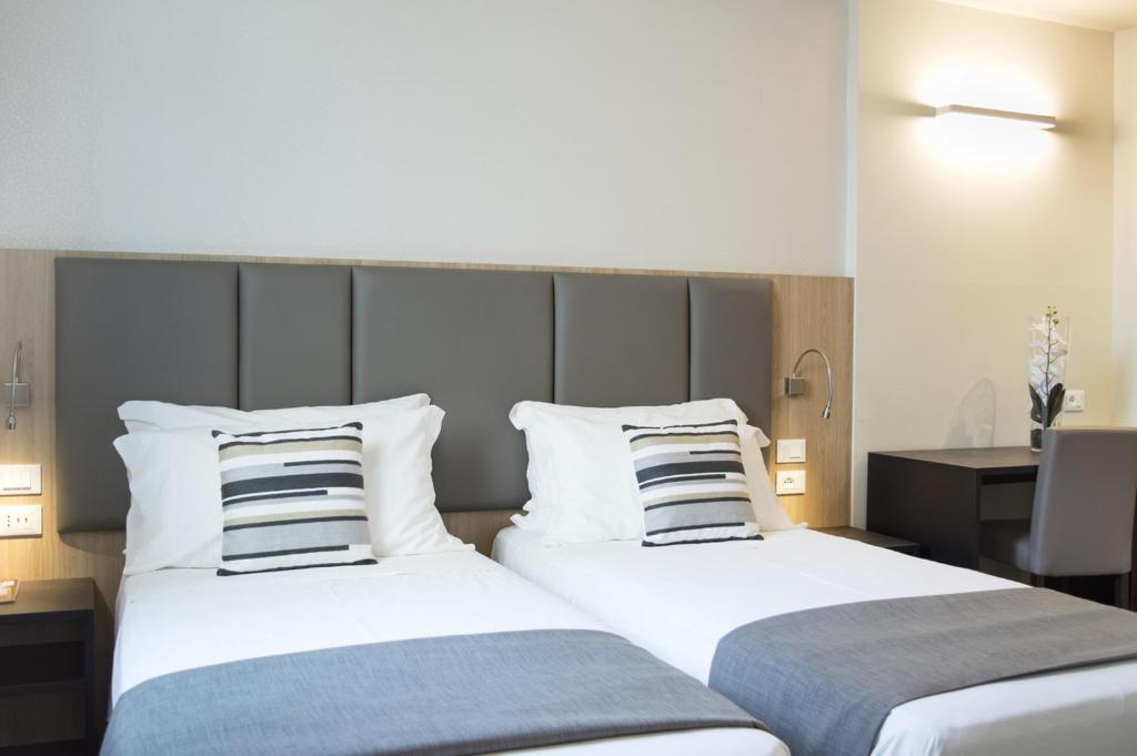 Postel nebo postele na pokoji v ubytování Hotel Alexander