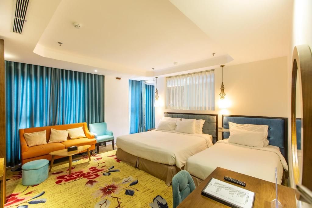 Postel nebo postele na pokoji v ubytování Adaline Hotel and Suite