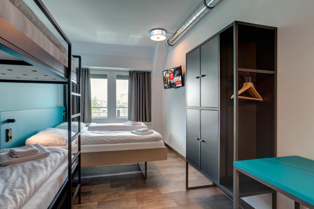 Postel nebo postele na pokoji v ubytování MEININGER Hotel München Olympiapark