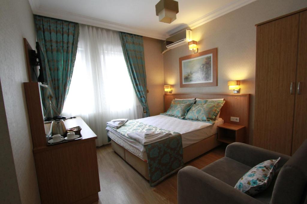 A bed or beds in a room at Agora Boutique Hotel & Bistro