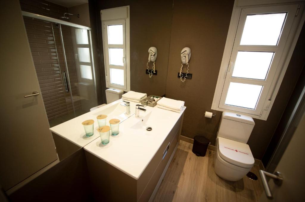 a bathroom with a sink and a toilet at Hotel Diufain in Conil de la Frontera