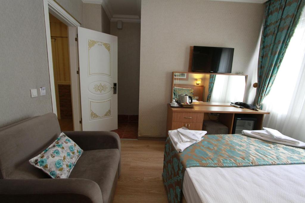 A bed or beds in a room at Agora Boutique Hotel & Bistro