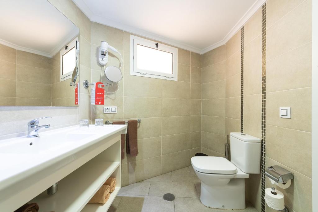 a bathroom with a sink and a toilet at Holiday Club Vista Amadores in Amadores
