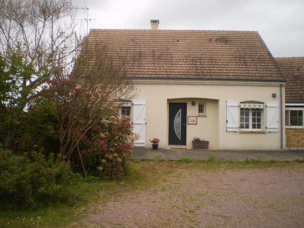 ein kleines weißes Haus mit einer schwarzen Tür in der Unterkunft Champagné in Champagné