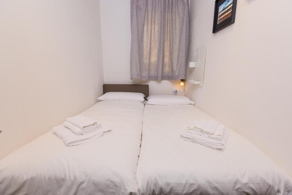 Łóżko lub łóżka w pokoju w obiekcie Mosina Apartments