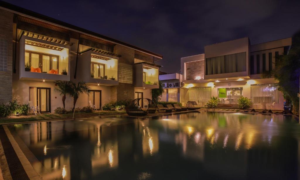 a swimming pool in front of a building at night at One Manalo Place in Puerto Princesa City