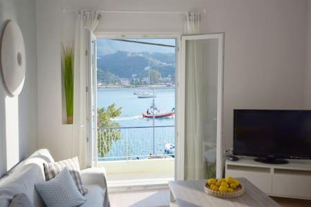 a living room with a view of the ocean at Beautiful house by the sea in Poros