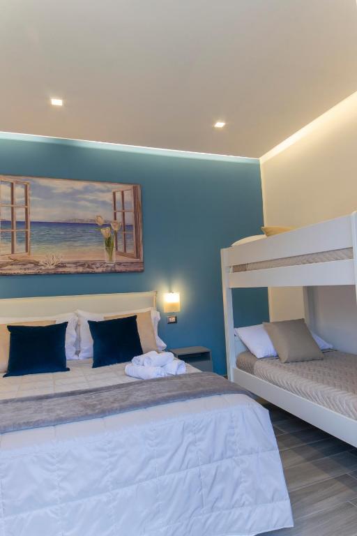 Posteľ alebo postele v izbe v ubytovaní B&B Maremy... I 4 Elementi