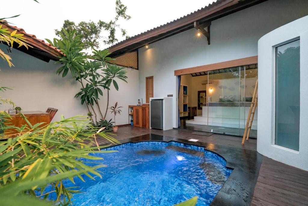 a swimming pool in the middle of a house at Stay Shark Villas Gili Air in Gili Islands