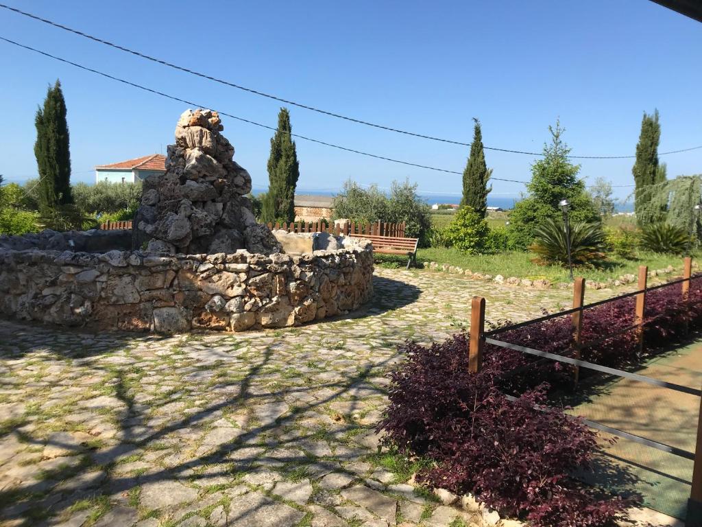 a stone monument in a yard with a fence at Il Podere del Carlone in Vasto