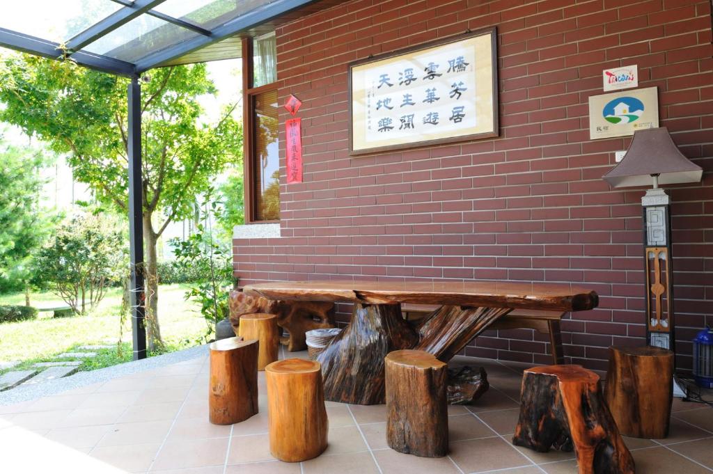 a wooden bench in front of a brick wall at TFG B&amp;B in Lugu Lake