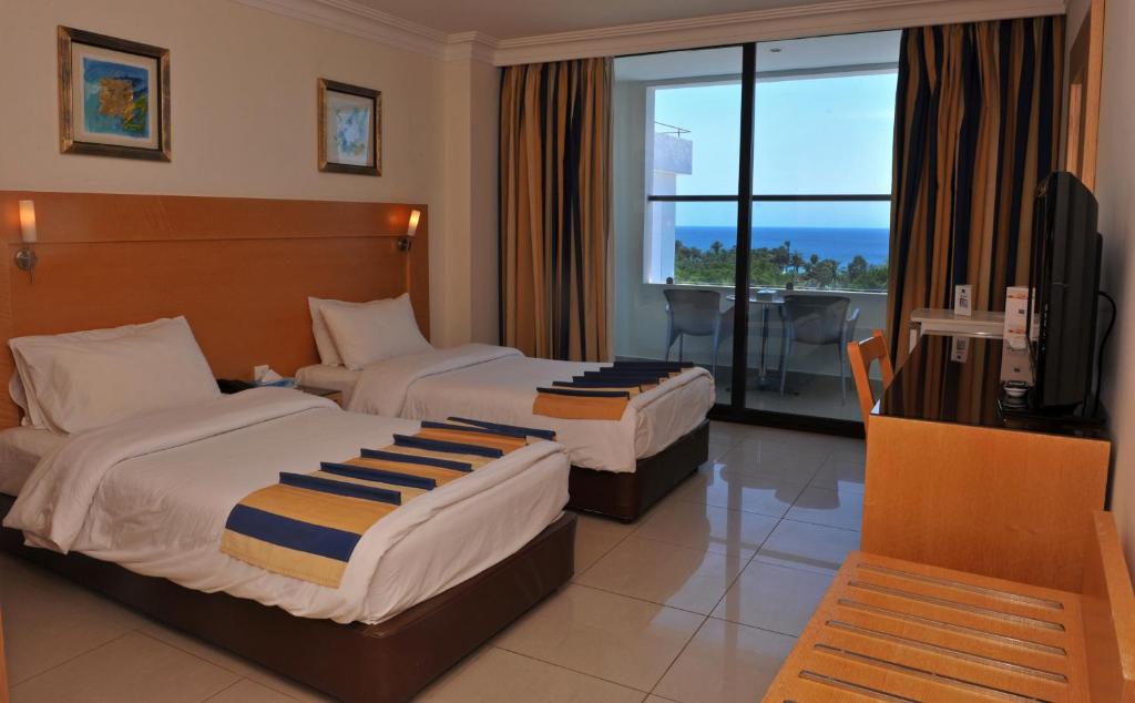 Postel nebo postele na pokoji v ubytování Mina Hotel