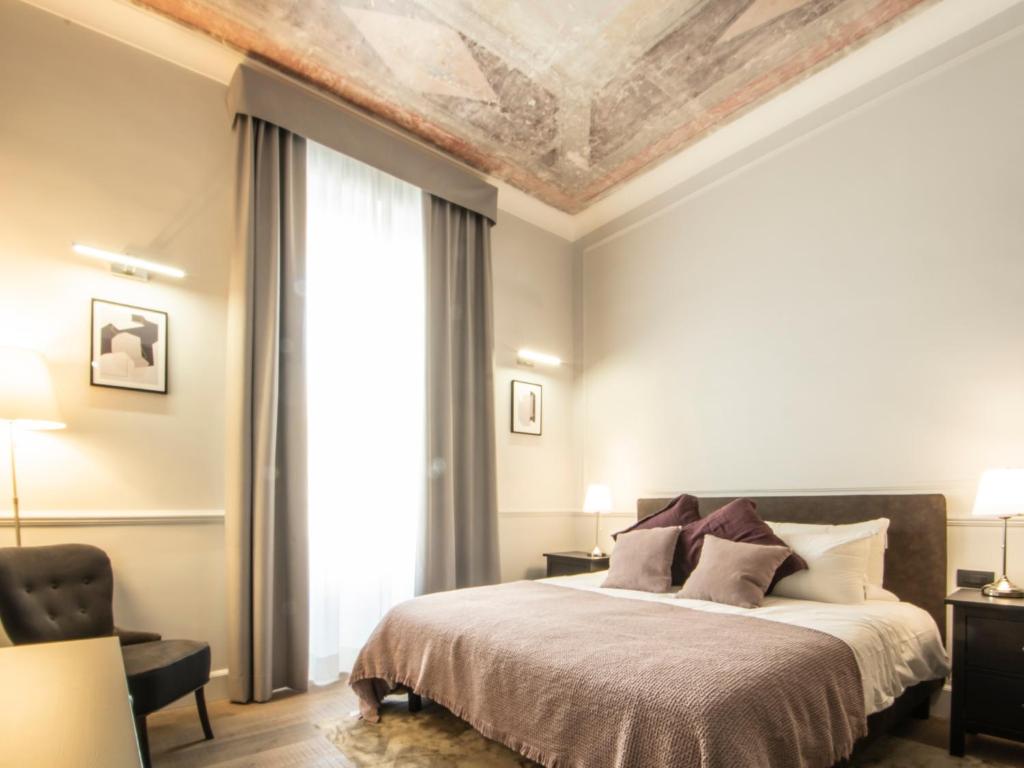 A bed or beds in a room at Holidays Suites Navona