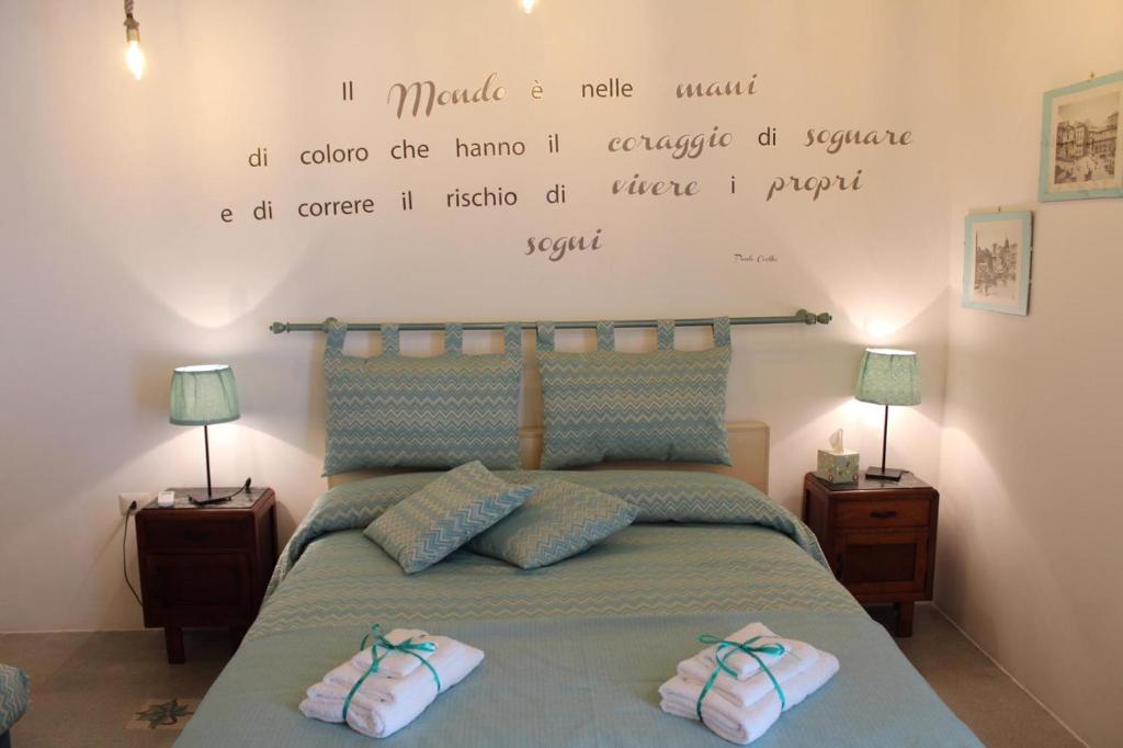 a bedroom with a bed with a quote on the wall at Dimora Via Col Vento in Naples