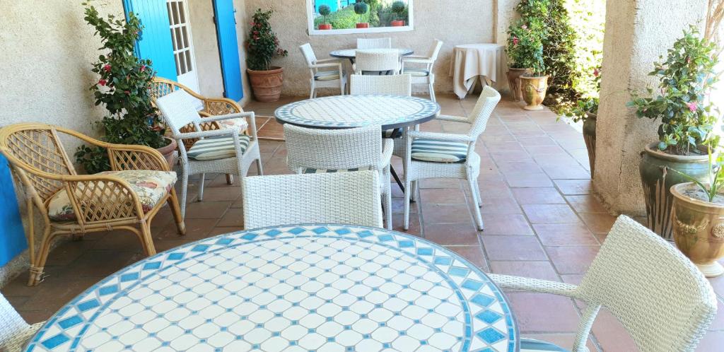 a patio with tables and chairs on a patio at Hôtel Saint Andre in Saint-Tropez
