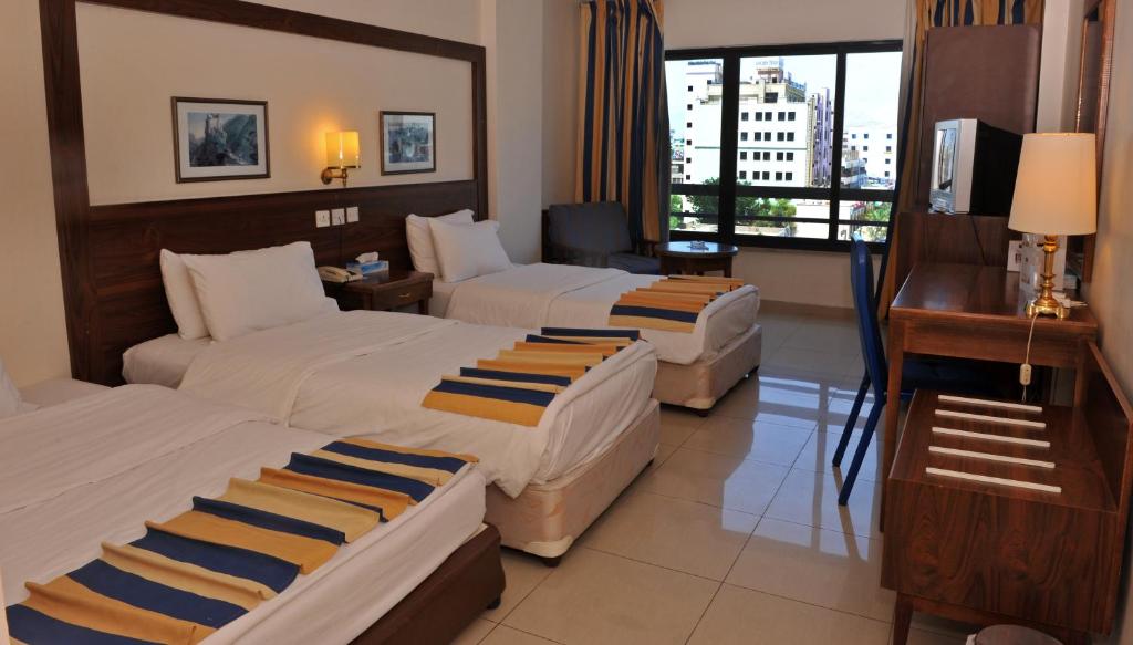 Postel nebo postele na pokoji v ubytování Mina Hotel