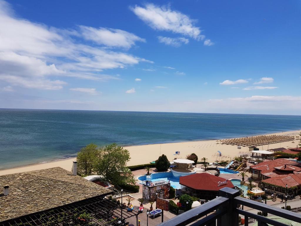 a view of a beach and the ocean from a balcony at Golden Sands Rentals Apartments in Golden Sands