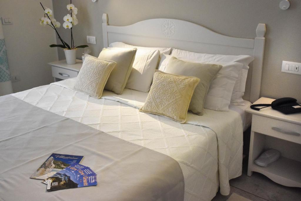 Postel nebo postele na pokoji v ubytování Hotel I Graniti