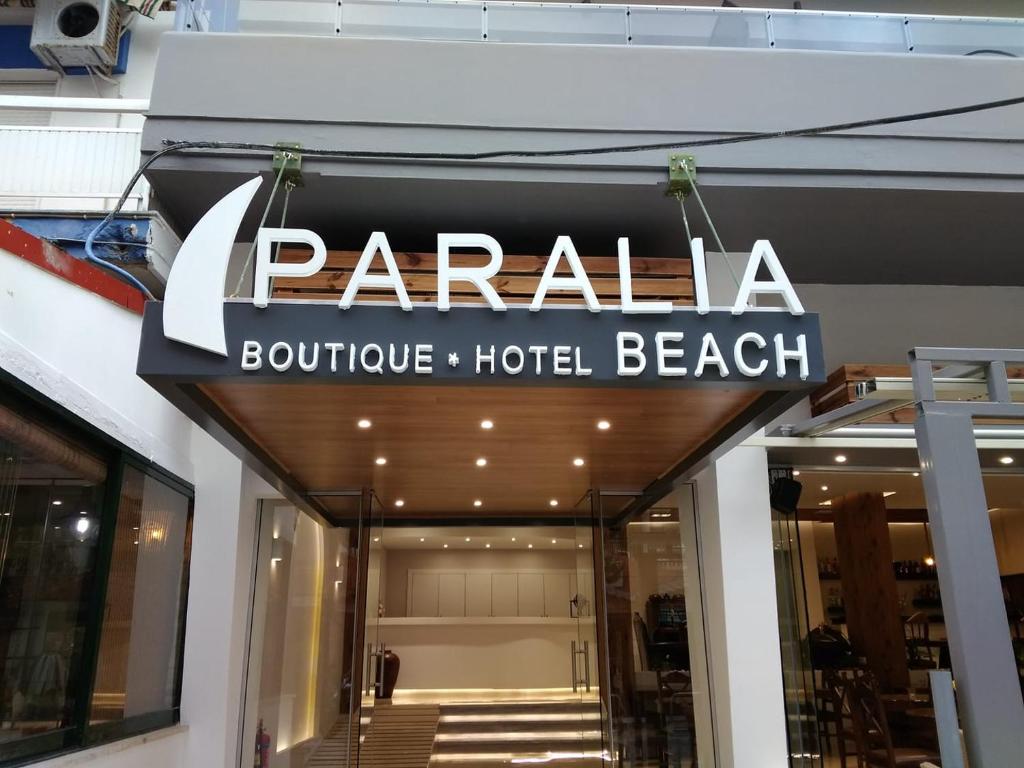 a sign for a beach hotel on the front of a building at Paralia Beach Boutique Hotel in Paralia Katerinis