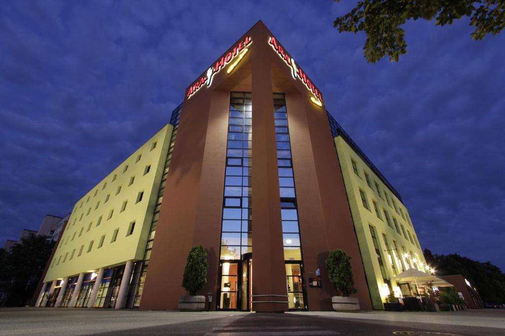 a large building with a sign on top of it at Ara Hotel Comfort in Ingolstadt