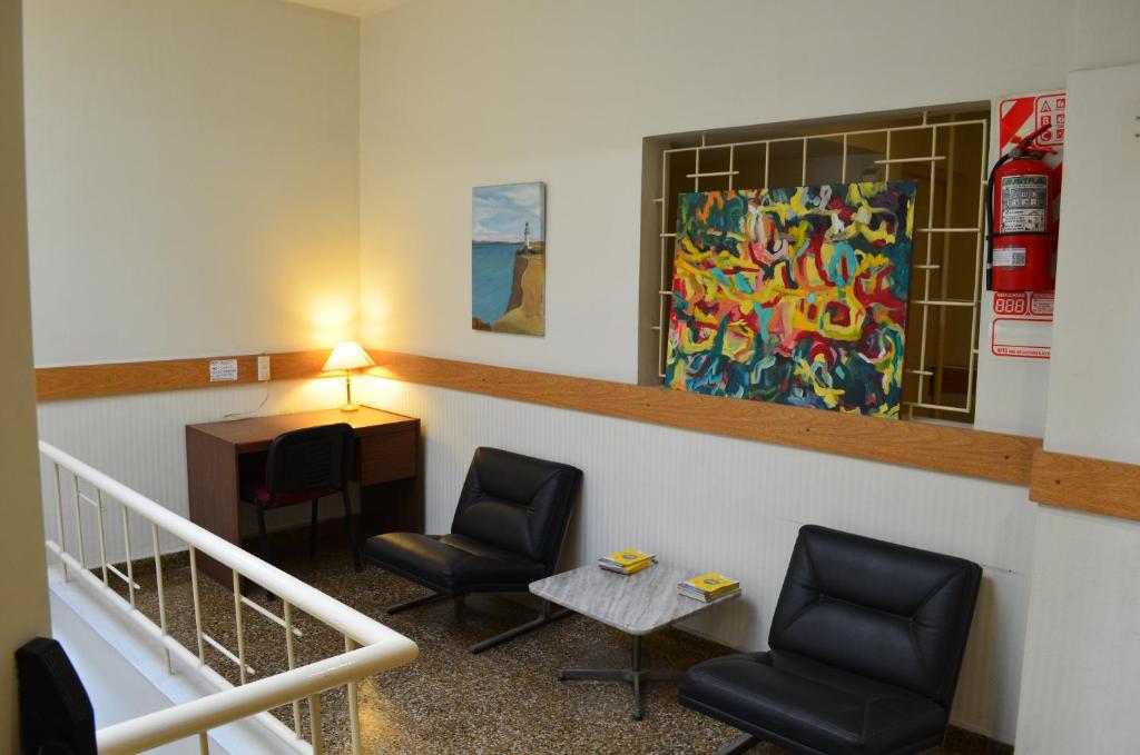 Hotel Gran Sarmiento في بوينس آيرس: غرفة انتظار مع كرسيين ومكتب