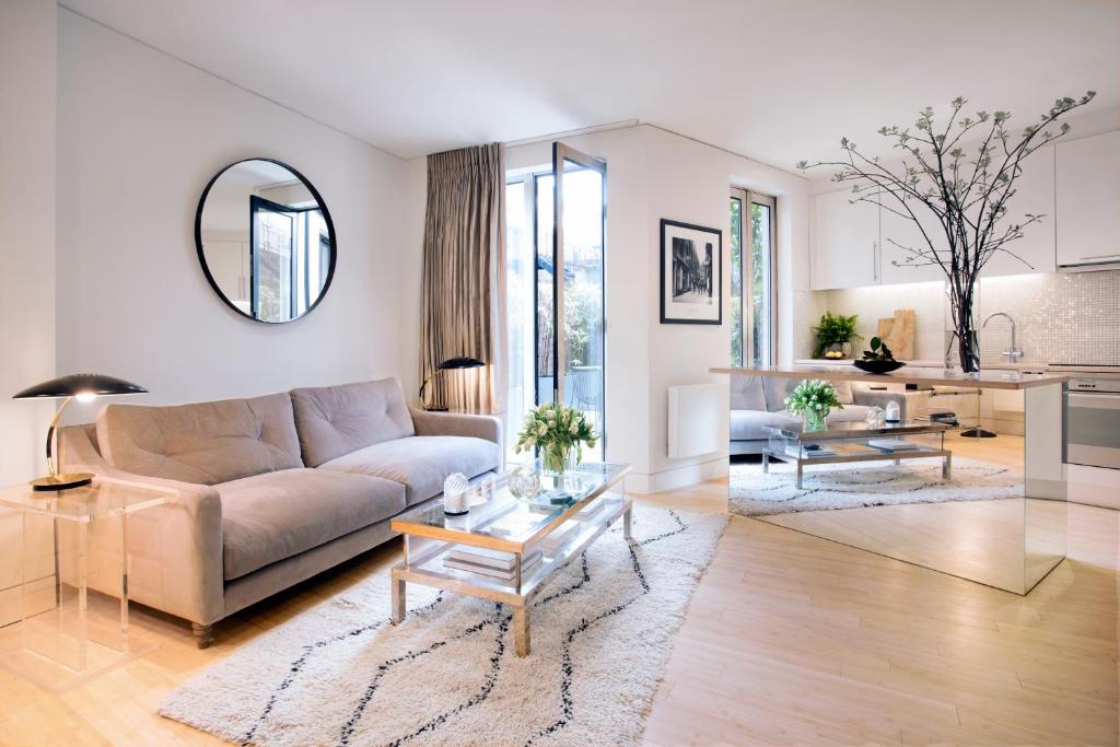 a living room with a couch and a table at No.5 Maddox Street in London