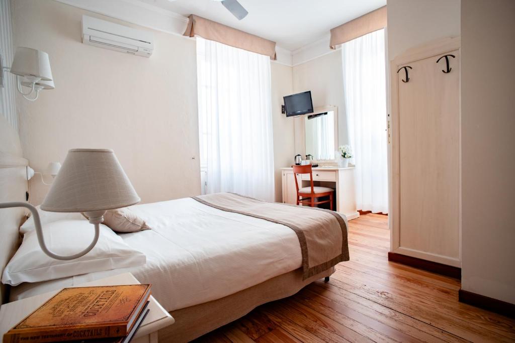 Łóżko lub łóżka w pokoju w obiekcie Hotel Villa Aurora
