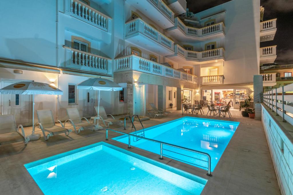 a swimming pool in the middle of a house at Irini Apartments in Hersonissos