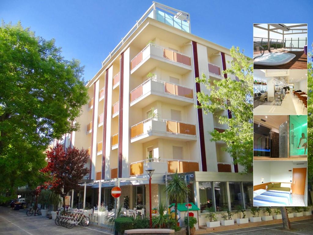 a large white building with balconies on a street at Hotel Aquila D'Oro in Misano Adriatico