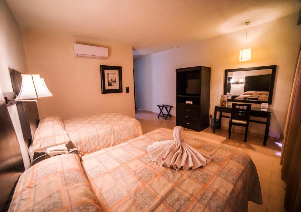 Postel nebo postele na pokoji v ubytování Hotel Marlon