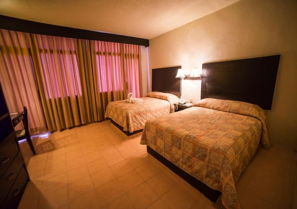 Postel nebo postele na pokoji v ubytování Hotel Marlon