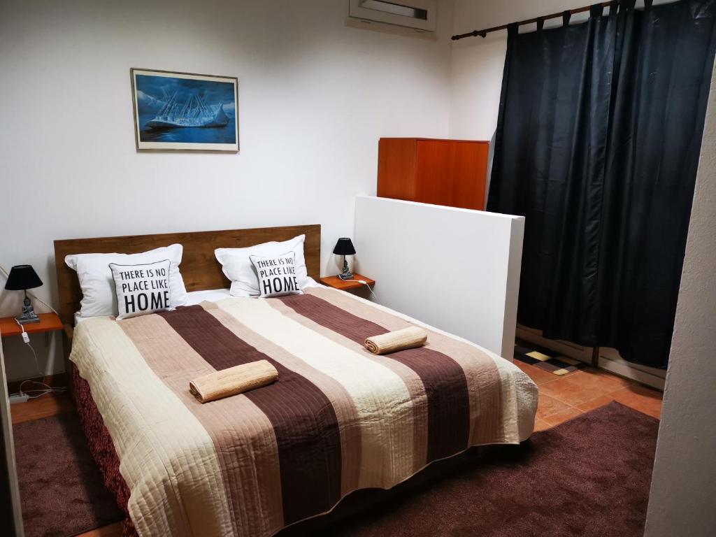 a bedroom with a bed with two pillows on it at Opus One apartment Dubrovnik - Private parking in Dubrovnik