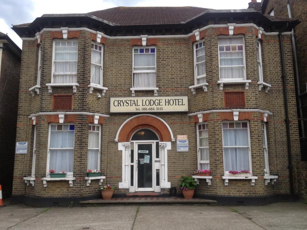 a brick building with a sign that reads crisfield lodge hotel at The Crystal Lodge Hotel in Croydon