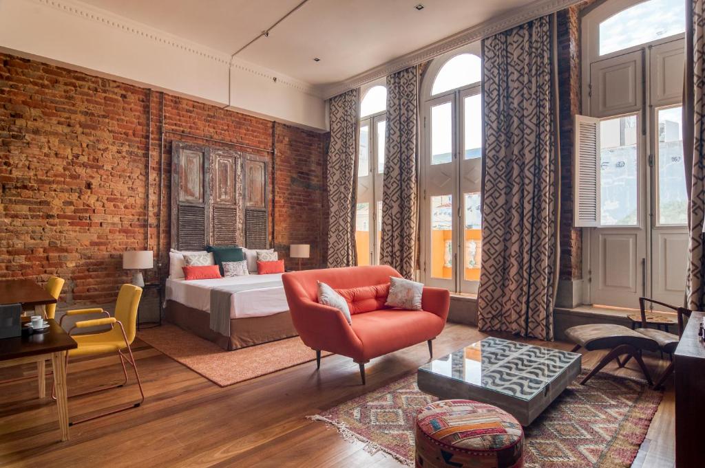 a living room with a brick wall at Selina Lapa Rio de Janeiro in Rio de Janeiro