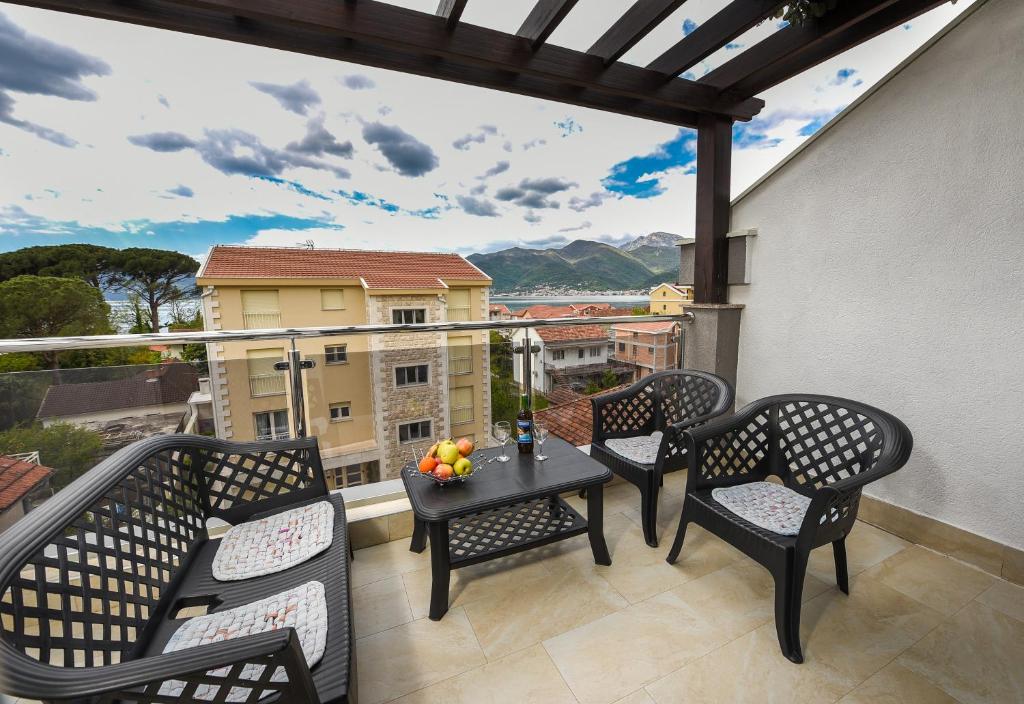 a balcony with chairs and a table with a view at Sea Point II Apart hotel Tivat in Tivat