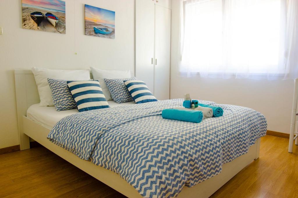 a bedroom with a bed with blue and white pillows at Villa Barbara in Split