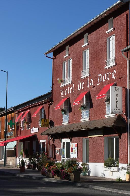a red brick building with a hotel of la junta at Logis Hôtel Restaurant de la Dore in Vertolaye