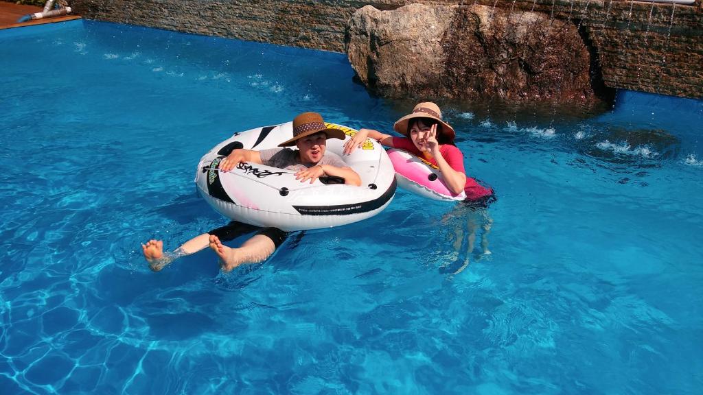 two people in the water in a raft in the water at Moon on the Cloud in Yeongwol