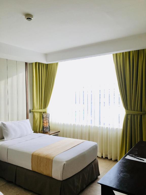 Postel nebo postele na pokoji v ubytování Belian Hotel