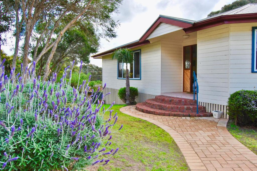 a house with purple flowers in front of it at Annie's Balquhidder Cottage in Victor Harbor