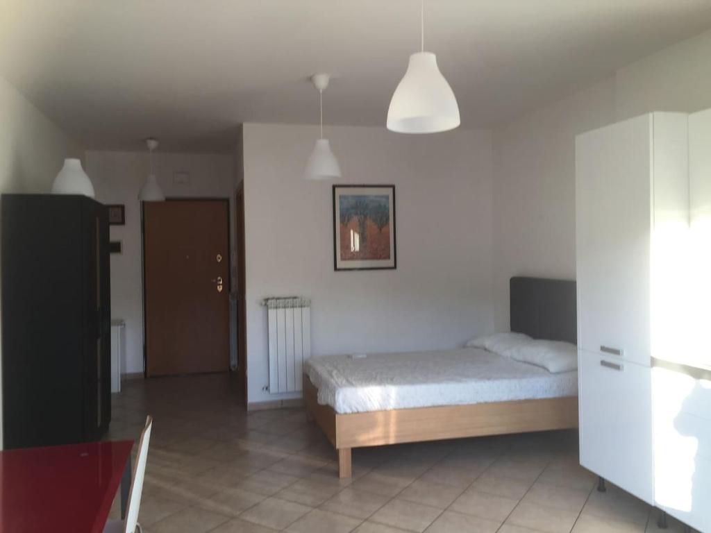 Łóżko lub łóżka w pokoju w obiekcie La Perla