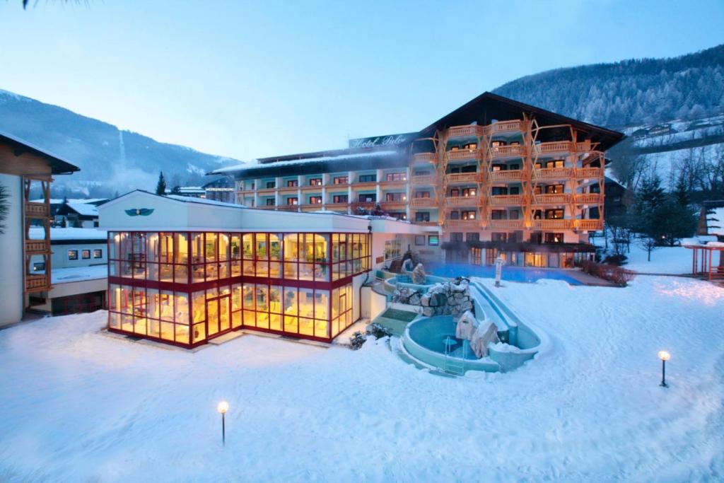 a resort resort with a ski lift and a ski lodge at Thermenwelt Hotel Pulverer in Bad Kleinkirchheim