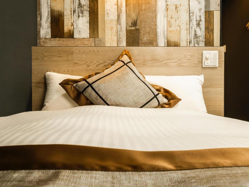 Postel nebo postele na pokoji v ubytování Hotel Areaone Kitaibaraki